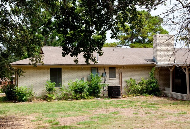 rear view of property with a lawn