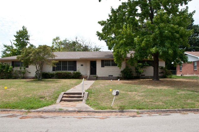 ranch-style home featuring a front yard