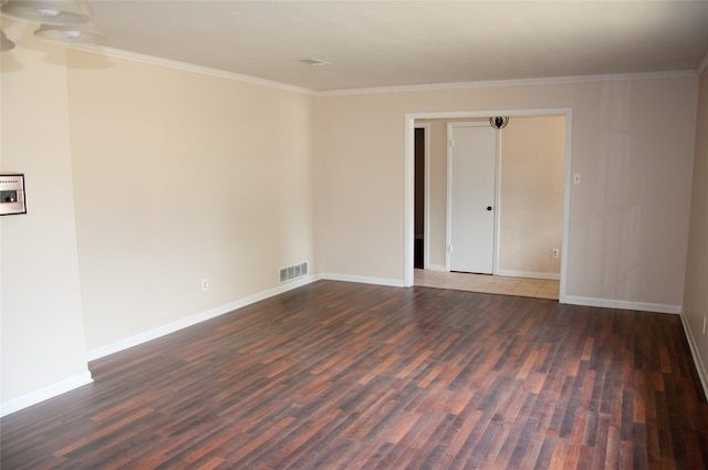 spare room featuring hardwood / wood-style flooring and crown molding