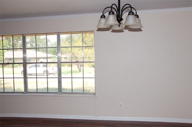 interior space with hardwood / wood-style floors, an inviting chandelier, and ornamental molding