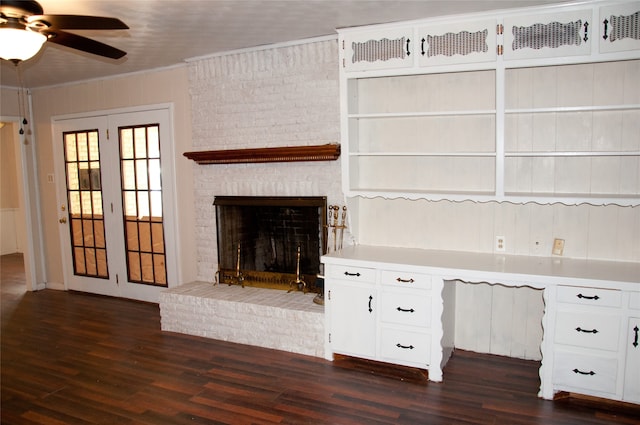 unfurnished living room featuring a fireplace, crown molding, dark hardwood / wood-style flooring, and ceiling fan