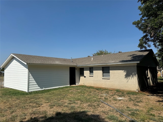 back of house with a lawn