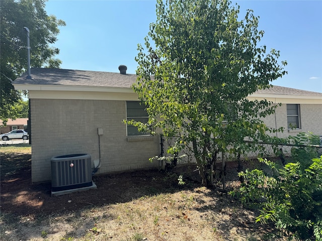 view of side of home featuring central AC