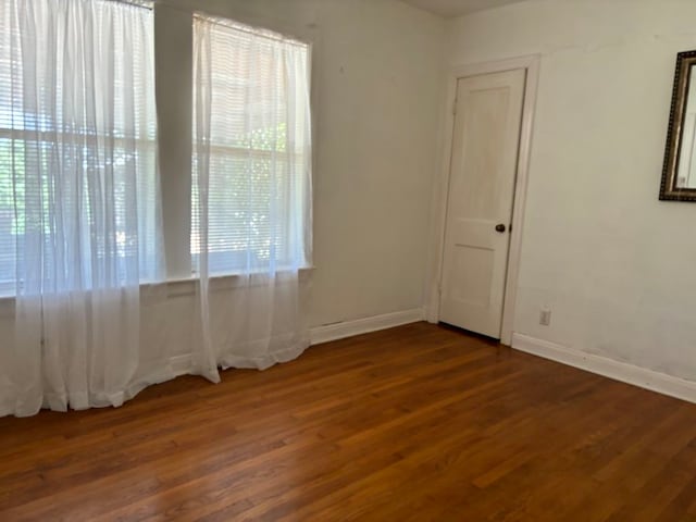 spare room with dark hardwood / wood-style floors