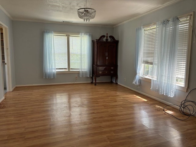 interior space featuring hardwood / wood-style floors, crown molding, and a healthy amount of sunlight