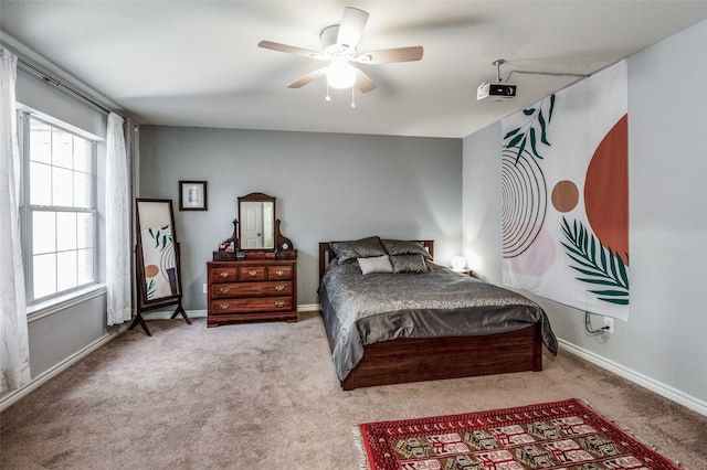 bedroom featuring light carpet and ceiling fan