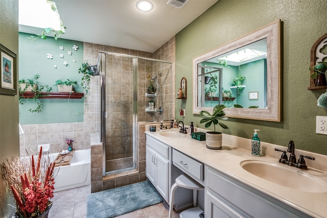 bathroom featuring vanity, independent shower and bath, a textured ceiling, and tile patterned flooring