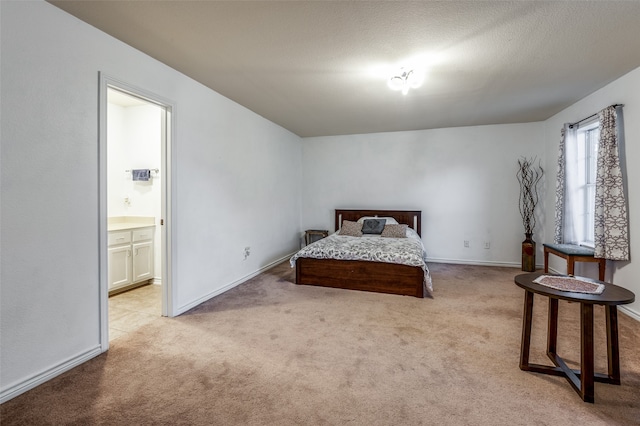 carpeted bedroom with ensuite bath