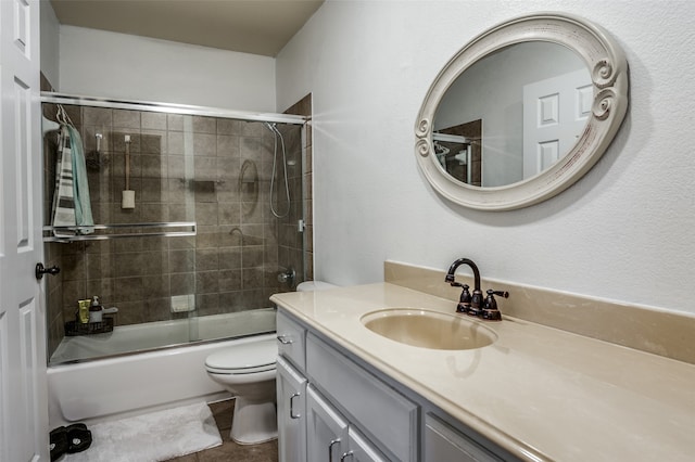 full bathroom featuring vanity, enclosed tub / shower combo, toilet, and tile patterned floors