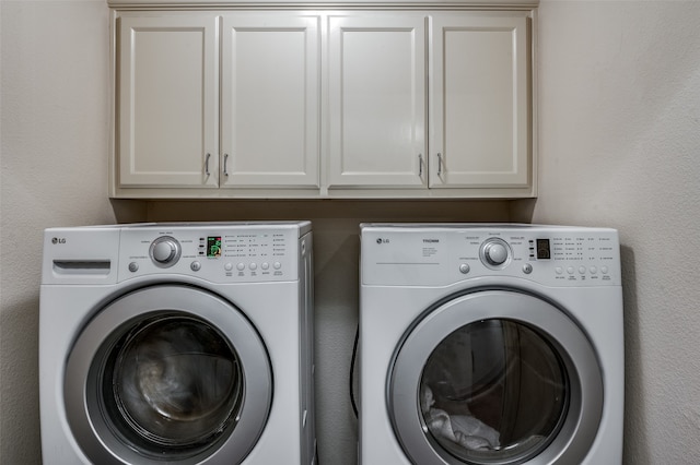 laundry area featuring cabinets and washer and dryer