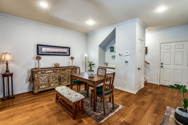 dining space with crown molding and dark hardwood / wood-style floors