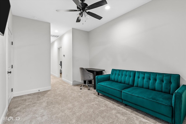 carpeted living room featuring ceiling fan