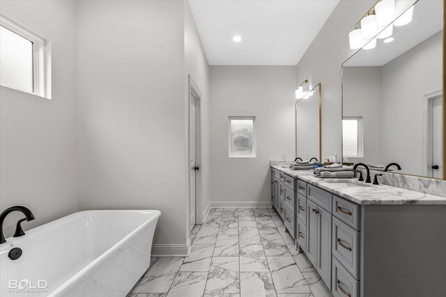 bathroom with vanity and a tub