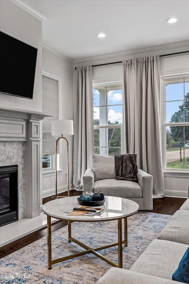 living room featuring dark hardwood / wood-style floors, plenty of natural light, and crown molding