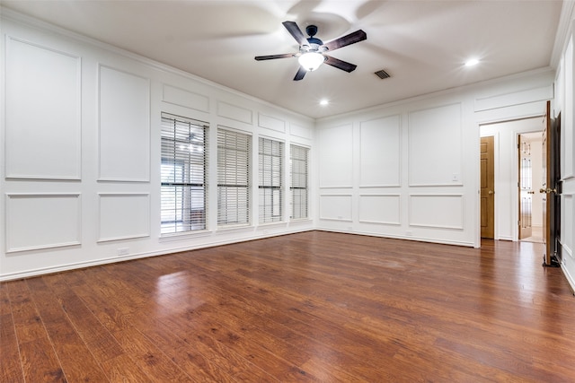 empty room with crown molding, dark hardwood / wood-style flooring, and ceiling fan