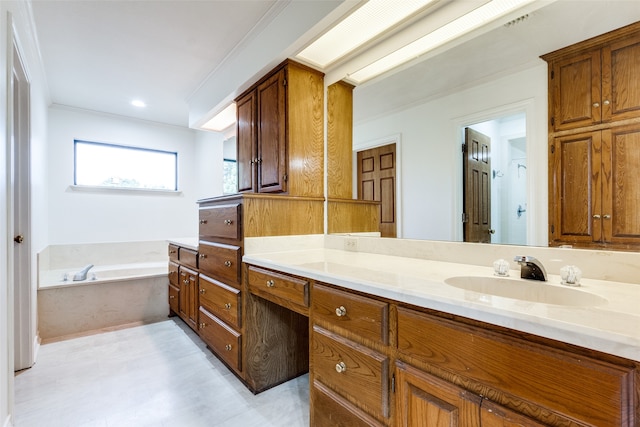 bathroom with crown molding, vanity, and a washtub