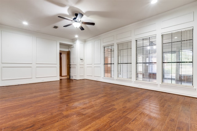 interior space featuring ceiling fan, hardwood / wood-style flooring, and crown molding