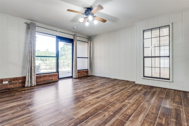 unfurnished room featuring ceiling fan, dark hardwood / wood-style floors, and ornamental molding