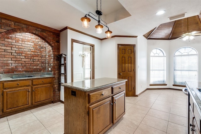 kitchen with black electric cooktop, light tile patterned floors, crown molding, a center island, and ceiling fan