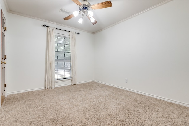 carpeted empty room with ceiling fan and crown molding