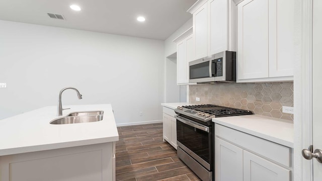 kitchen featuring sink, white cabinets, and appliances with stainless steel finishes