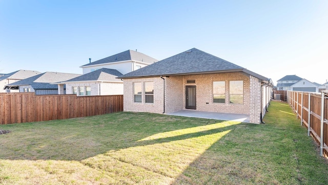 rear view of property with a lawn and a patio area