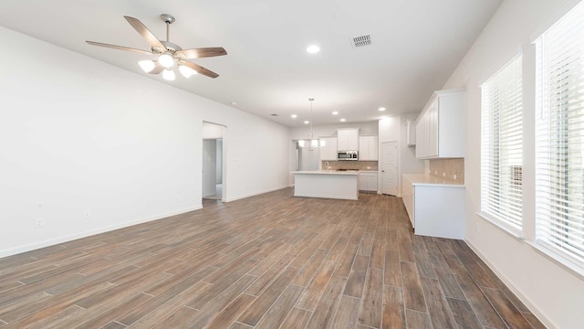 unfurnished living room featuring ceiling fan