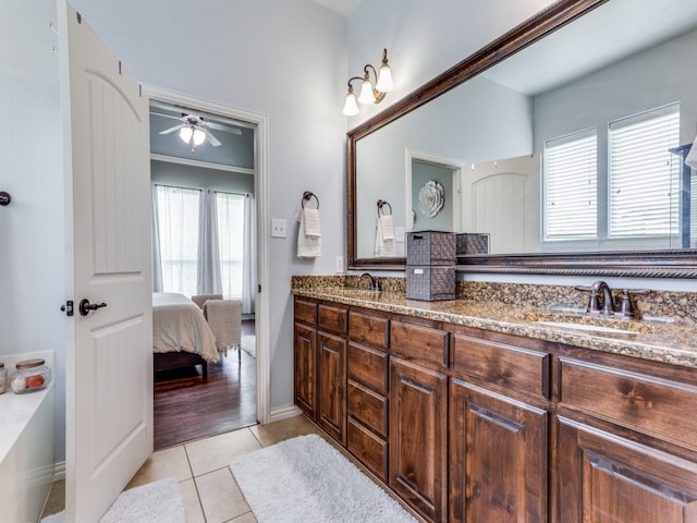 bathroom featuring a wealth of natural light, tile patterned floors, ceiling fan, and vanity