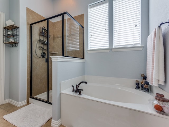 bathroom featuring tile patterned flooring and separate shower and tub