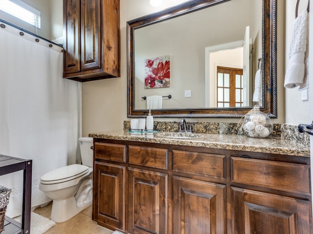 bathroom with vanity, tile patterned flooring, and toilet