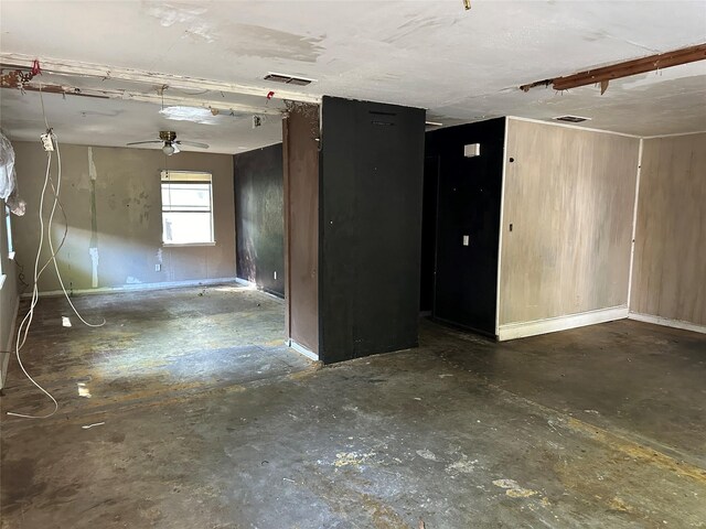 spare room with ceiling fan and concrete floors