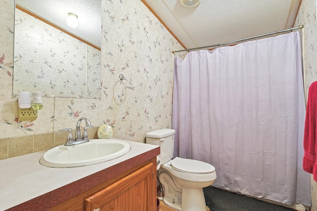 bathroom featuring a textured ceiling, toilet, and vanity