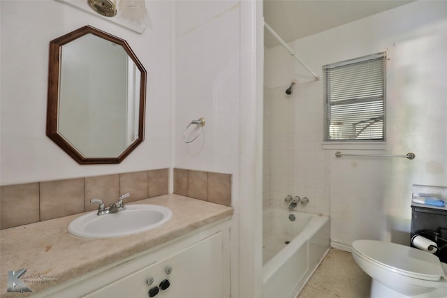 full bathroom featuring tiled shower / bath, vanity, toilet, and tile patterned flooring