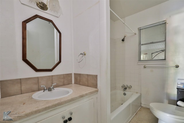 full bathroom with vanity, tiled shower / bath, and toilet