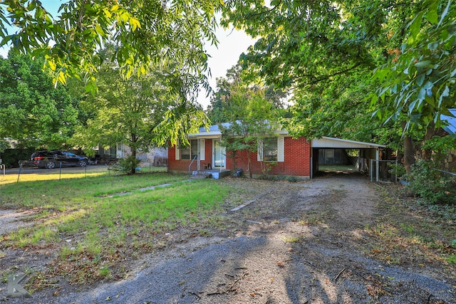 view of front facade with a front yard and a carport