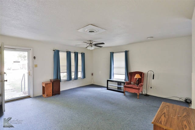 unfurnished room featuring ceiling fan, carpet, and a wealth of natural light