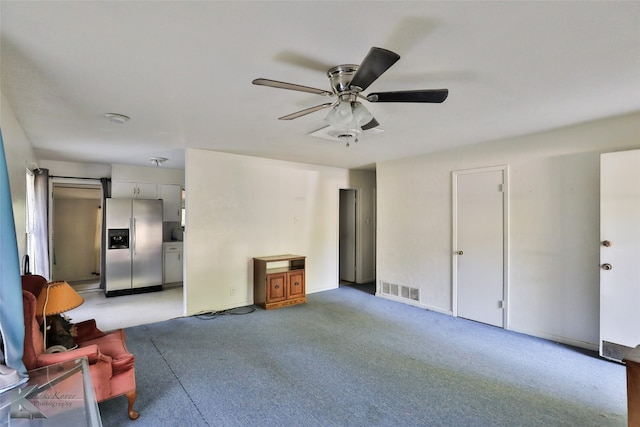 interior space featuring ceiling fan, carpet, and stainless steel fridge