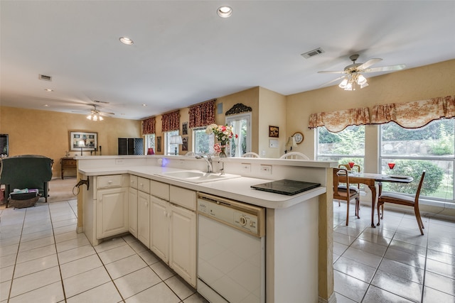 kitchen with a center island with sink, light tile patterned flooring, sink, and dishwasher