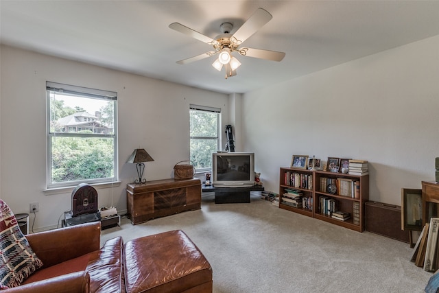 sitting room with ceiling fan, light colored carpet, and a wealth of natural light