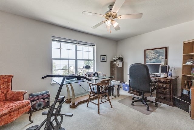 carpeted office space with ceiling fan