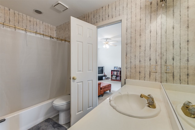 full bathroom with shower / bath combo, toilet, vanity, and ceiling fan