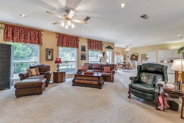 carpeted living room with ceiling fan