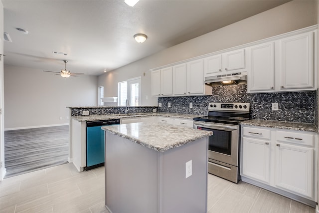 kitchen featuring ceiling fan, white cabinetry, light tile patterned floors, stainless steel appliances, and a kitchen island