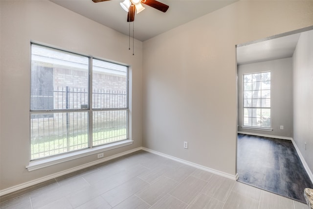 empty room featuring ceiling fan, light hardwood / wood-style flooring, and plenty of natural light