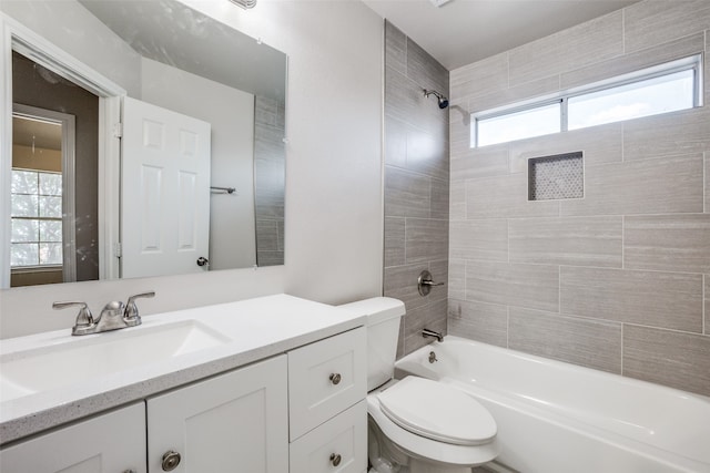 full bathroom featuring vanity, toilet, and tiled shower / bath