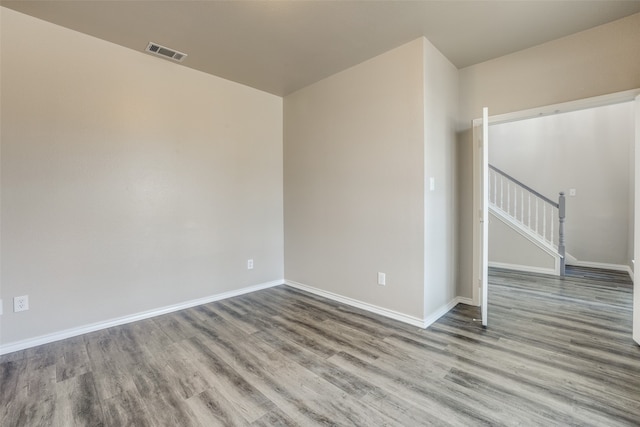 unfurnished room with wood-type flooring