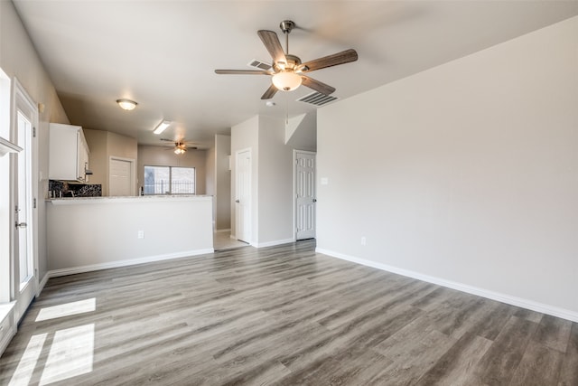 unfurnished living room featuring ceiling fan and light hardwood / wood-style floors