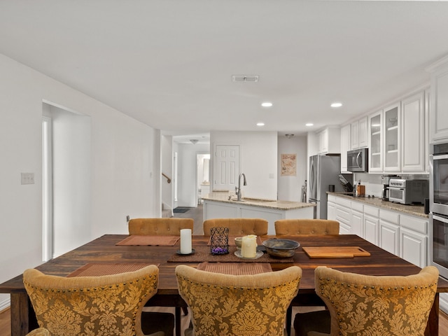 dining space with recessed lighting, a toaster, visible vents, and stairway