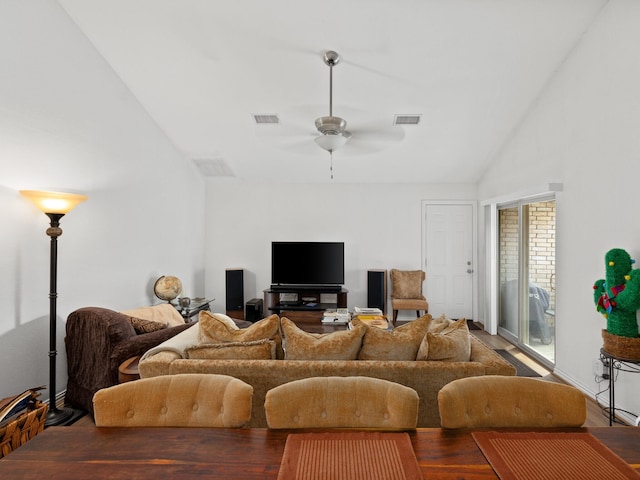 living room featuring lofted ceiling, visible vents, and ceiling fan