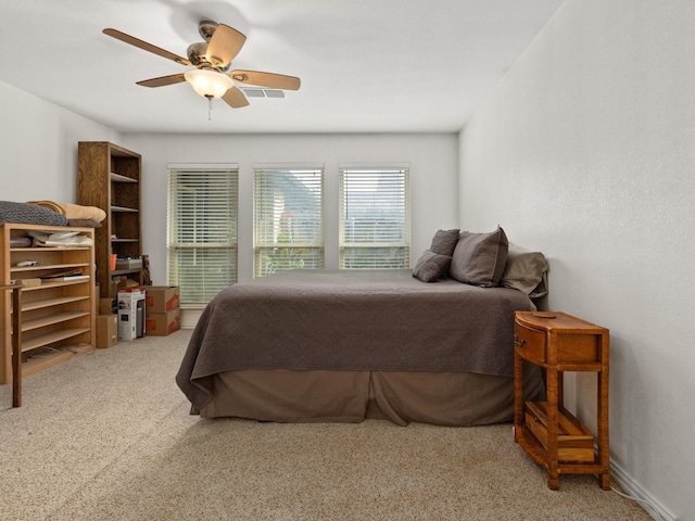 carpeted bedroom with visible vents and ceiling fan